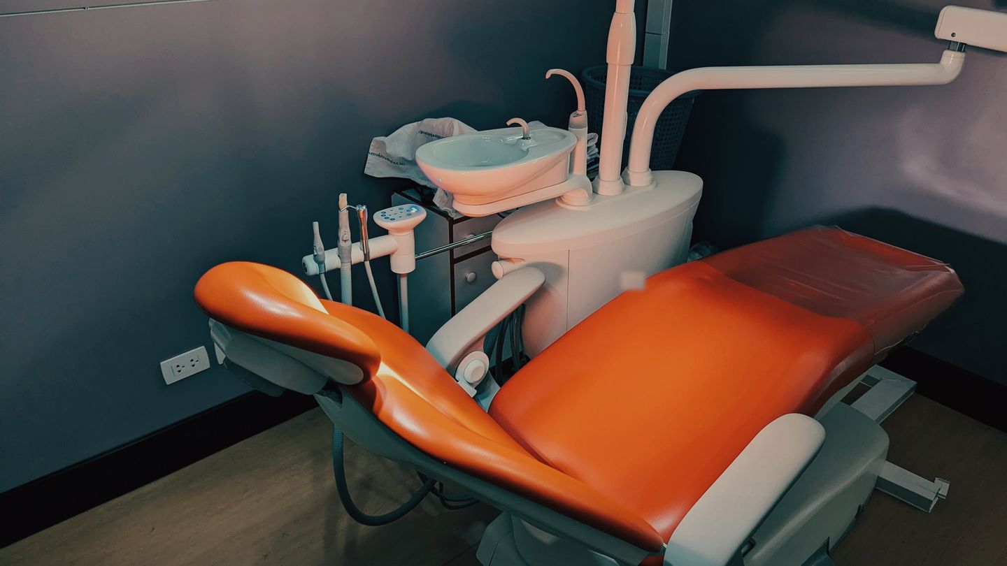 Illustrative image: an empty dental surgery in low evening light